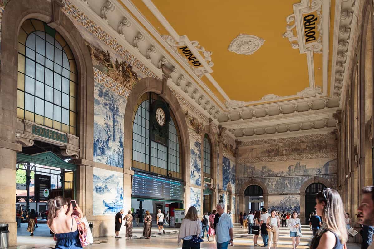 Azulejo tile panels and golden ceiling in the Sao Bento train station entrance hall