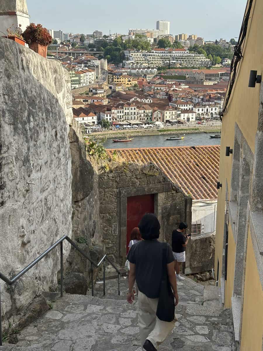 Stone stairs descending through narrow alleys toward Ribeira in Porto