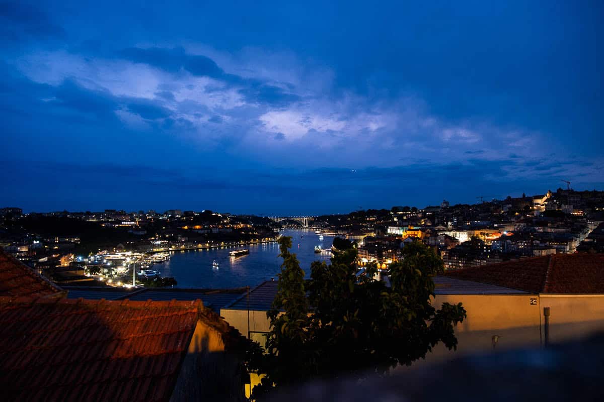 Blue hour view over the Douro River and city lights from Jardim do Morro