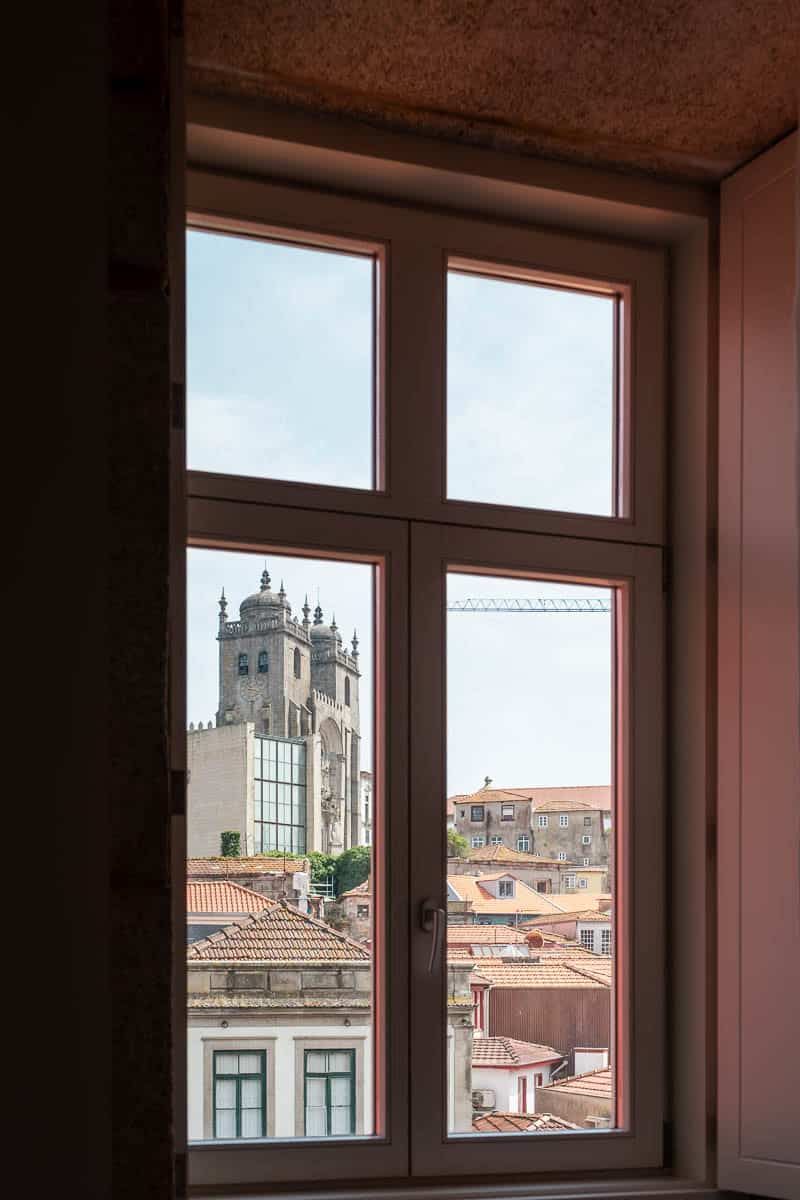 Porto Cathedral towers framed through an apartment window on Rua das Flores