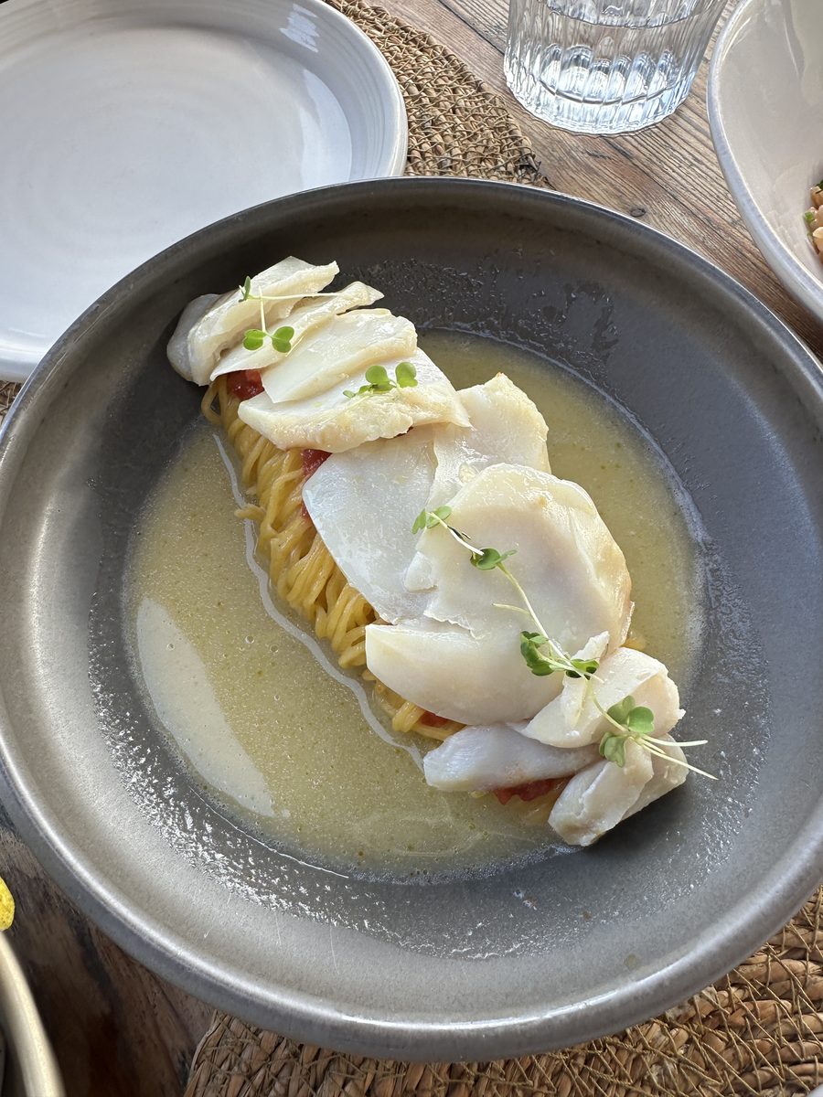 Seafood served over pasta at a waterfront restaurant in Ribeira